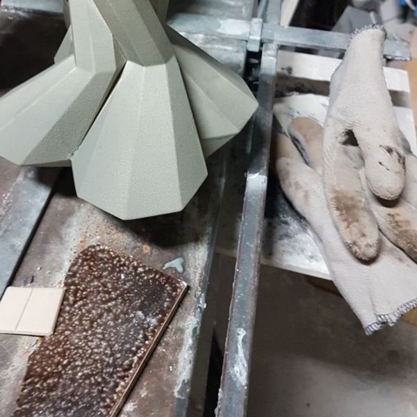 Geometric ceramic object and glaze samples in ceramic studio process