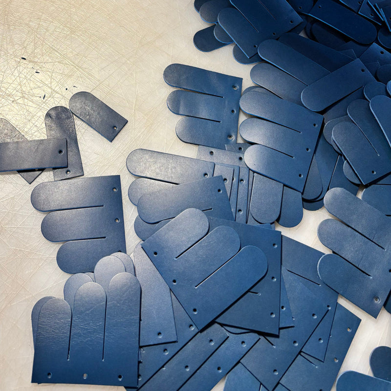 Blue saddle leather components prepared for handcrafted furniture production, Betsy Collection