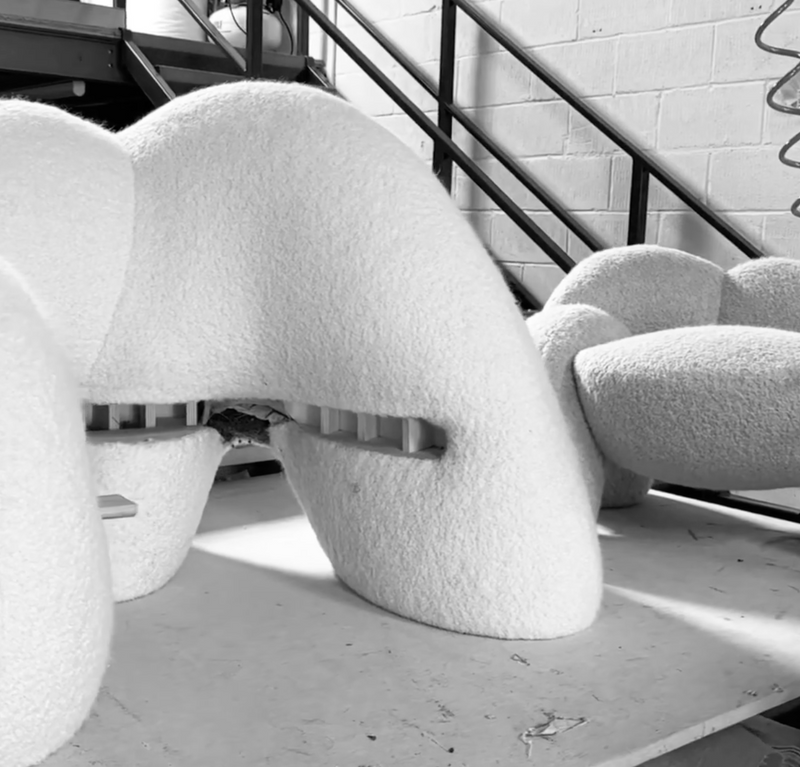 Soft sculptural upholstered furniture detail in textured white fabric during production, Anima Collection